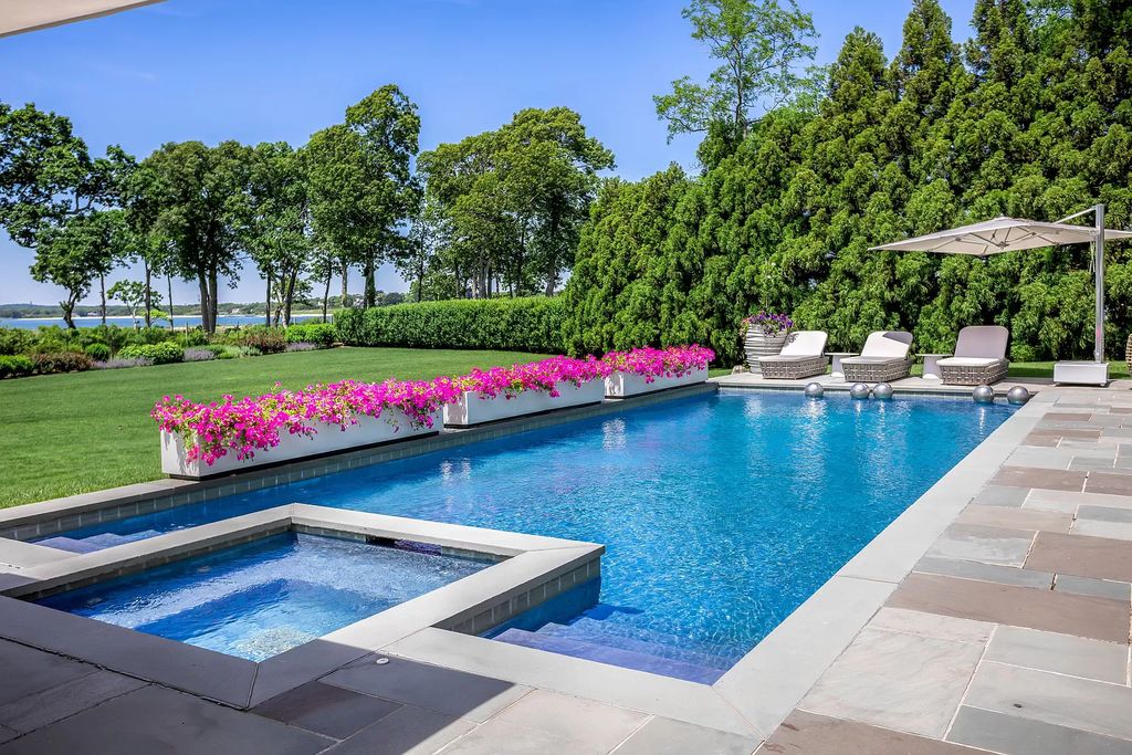 The Home in Sag Harbor, a gated residence set on a truly unique and special location with over 400 feet of direct waterfront and multiple entertaining spaces is now available for sale. This home located at 35 Ezekills Holw, Sag Harbor, New York