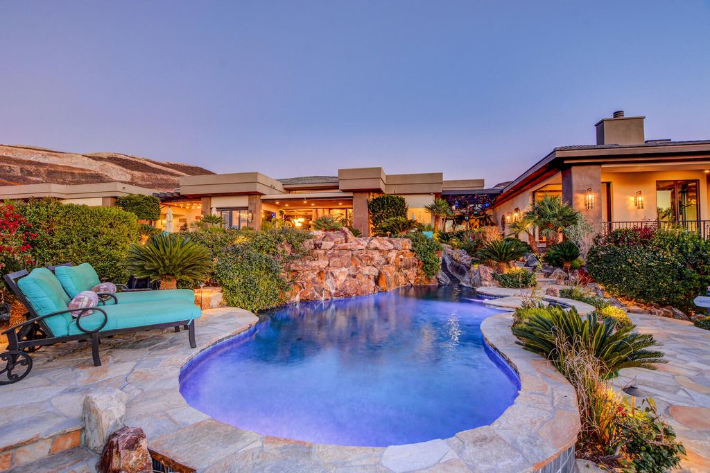 The Home in Henderson, a one of a kind estate has a jaw dropping resort style backyard with stunning 180 degree views of the Vegas Strip and the entire Vegas Valley. This home located at 677 Boulder Summit Dr, Henderson, Nevada.