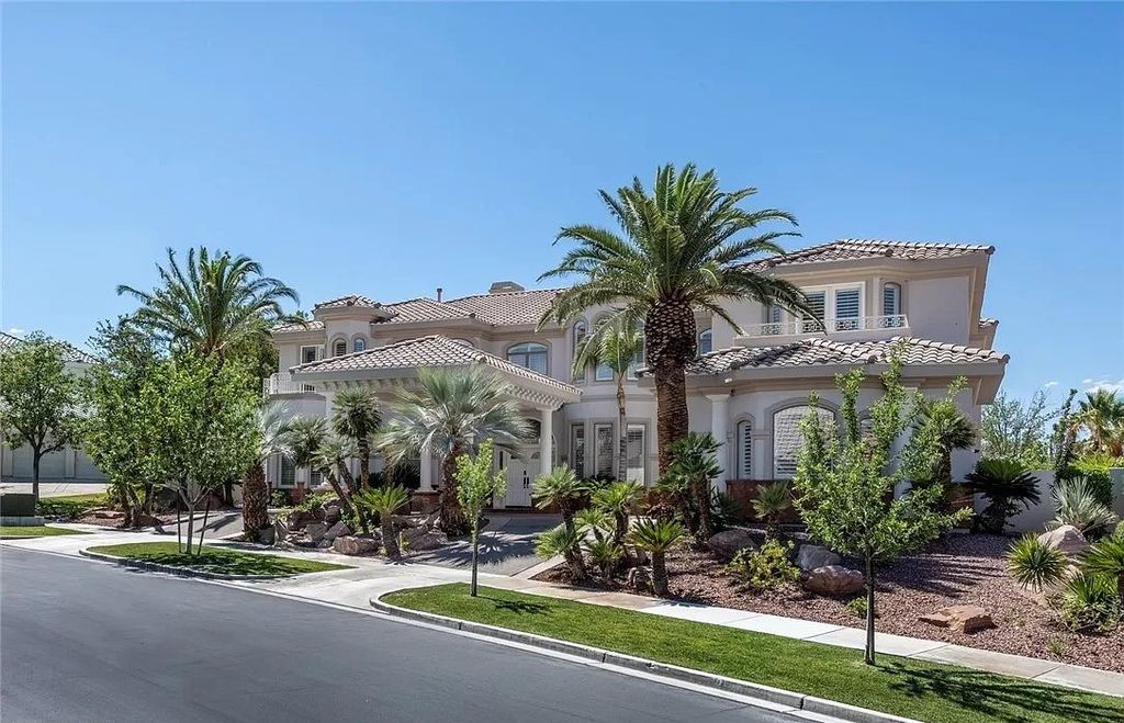 The Home in Las Vegas is a grand residence greeted by floor to ceiling windows showcasing the sky, mountains and golf course setting on a sought after guard gated golf communities now available for sale. This home located at 1425 Iron Hills Ln, Las Vegas, Nevada