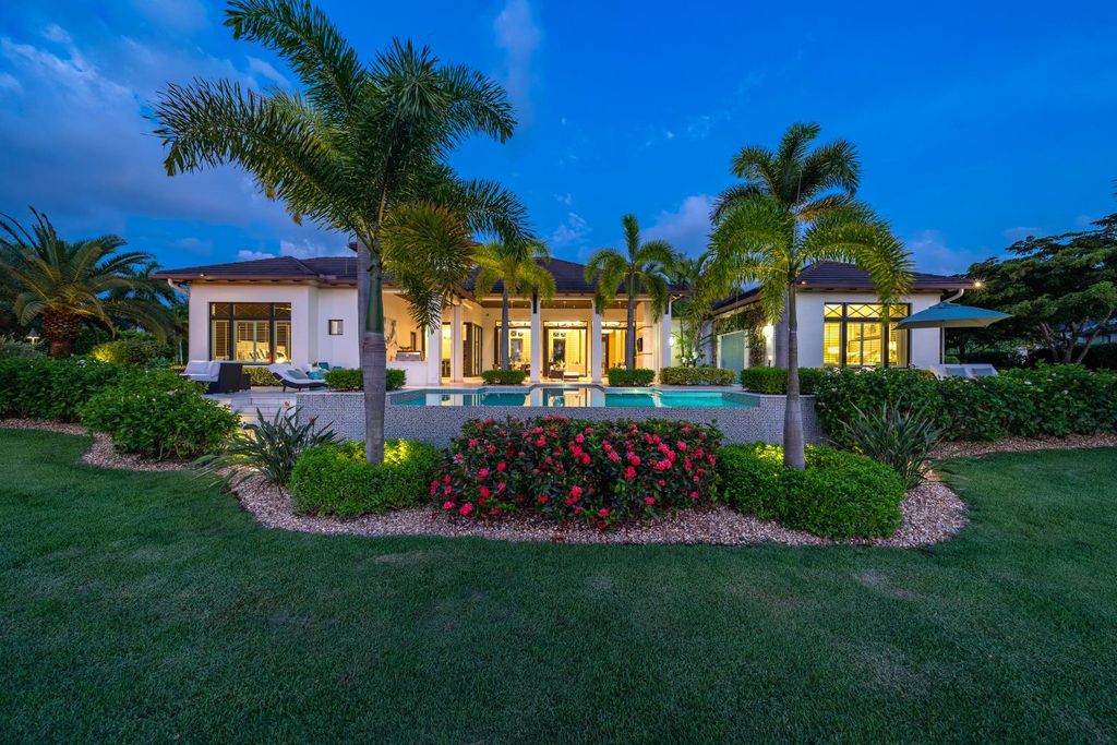 The Home in Naples is a jaw-dropping residence features an open family room with custom built-ins and architectural ceilings now available for sale. This home located at 13901 Williston Way, Naples, Florida