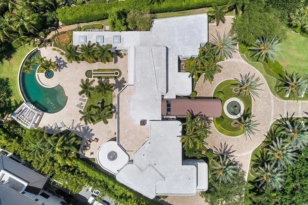The Home in Boca Raton, a beautiful contemporary estate was tastefully reconstructed, offers extreme privacy surrounded by lush tropical palm trees  is now available for sale. This home located at 18211 Long Lake Dr, Boca Raton, Florida