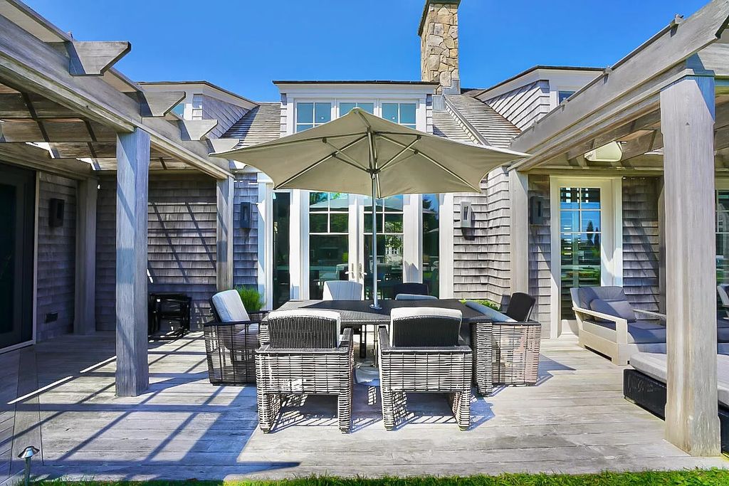 The House in Edgartown features cathedral ceilings throughout and an open floor plan with large living room, dining room and kitchen, now available for sale. This home located at 30 Crackatuxet Cove Road, Edgartown, Massachusetts