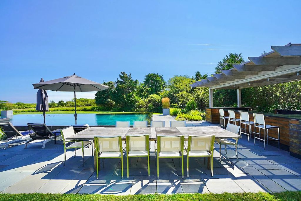The House in Edgartown features cathedral ceilings throughout and an open floor plan with large living room, dining room and kitchen, now available for sale. This home located at 30 Crackatuxet Cove Road, Edgartown, Massachusetts