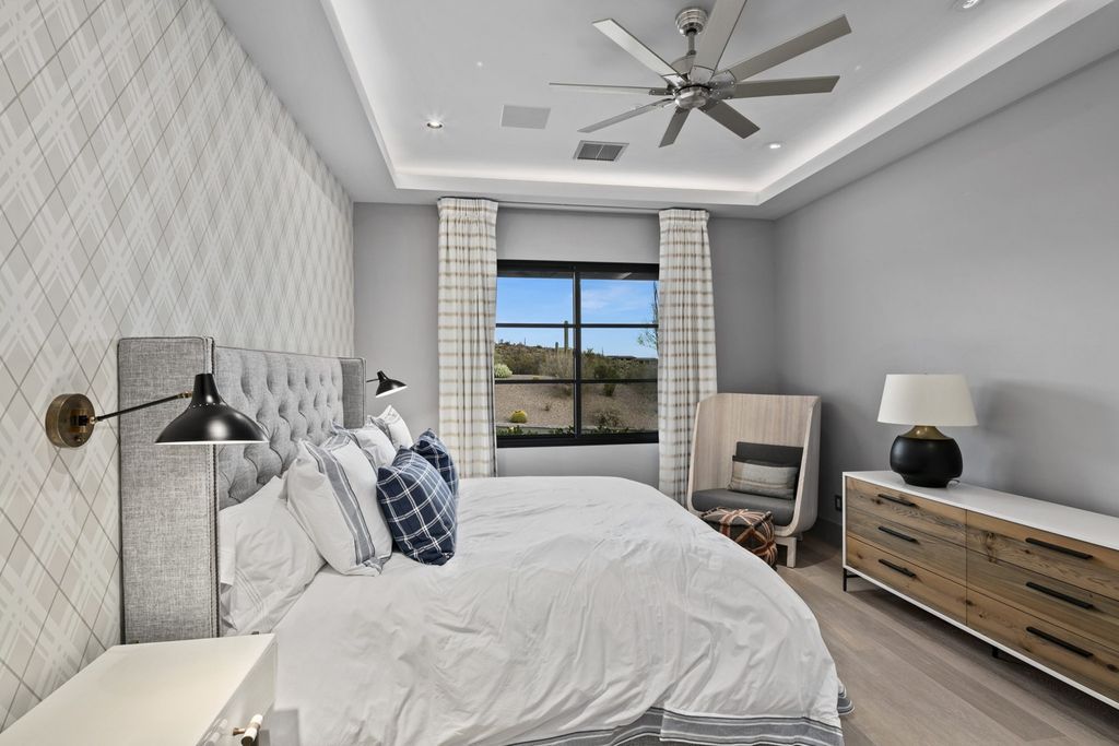 Here is a more formal interpretation of a neutral bedroom decor. To soften and humanize the scale of the room, there are several textiles used in this design. The warm greige colors ensure that it doesn't feel cold or ethereal despite the very high ceilings.