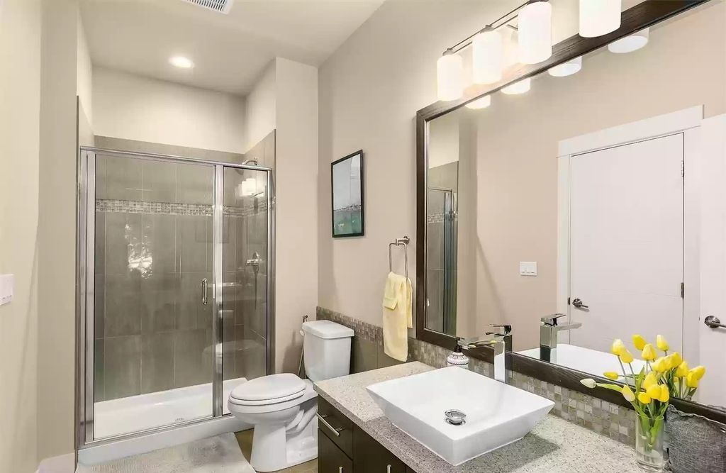 Blending a variety of tile colors and textures may provide interest to a bathroom backsplash. The harsh white subway tile in this primary bathroom contrasts well with the green mosaic tiles. The low-cost tiles continue onto the floor, creating a low-cost geometric impression.