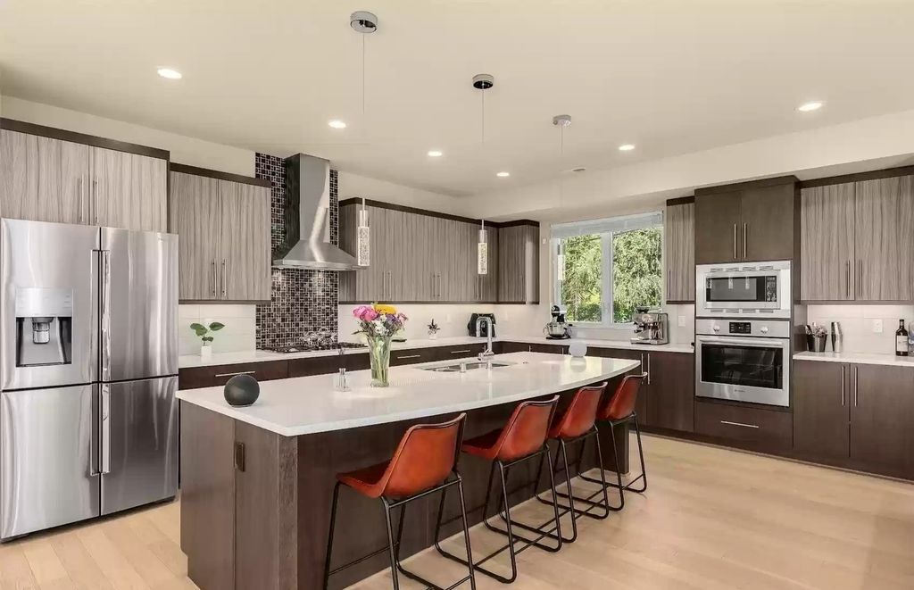 You may incorporate brown with other color tones for your kitchen cabinets, but it's crucial to ensure a harmonious color scheme. As shown in the luxury idea above, combining brown for lower cabinets with patterned grey for upper cabinets creates a perfectly balanced and stunning overall look. 
