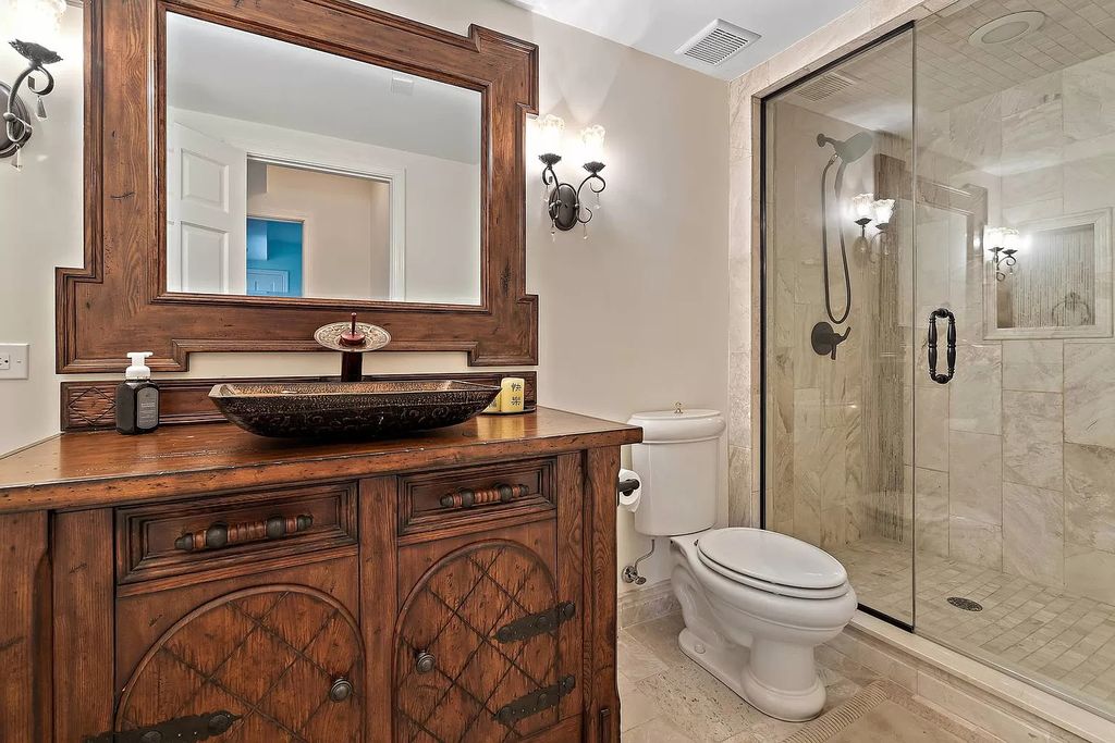 You can't go wrong with natural wood furniture and neutral bathroom colors. Try adding a copper washbasin and an oak-framed mirror to create a contrast with the glass-walled shower.