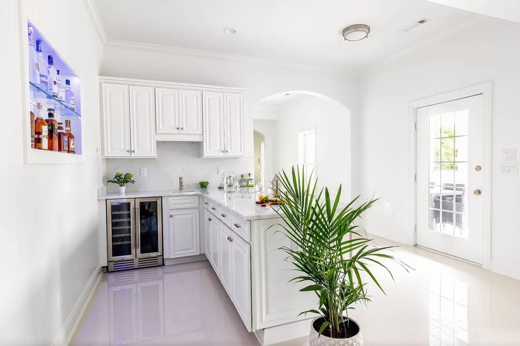 The L-shaped kitchen layout has cupboards and appliances arranged in a shape like a letter L. It's great for small kitchens because it makes good use of corner space and feels open. This layout is perfect for people who want to use corners effectively and create a natural flow between the sink, stove, and refrigerator. If you need more space, you can add a kitchen island or peninsula to the L-shape to make it bigger and provide extra storage.