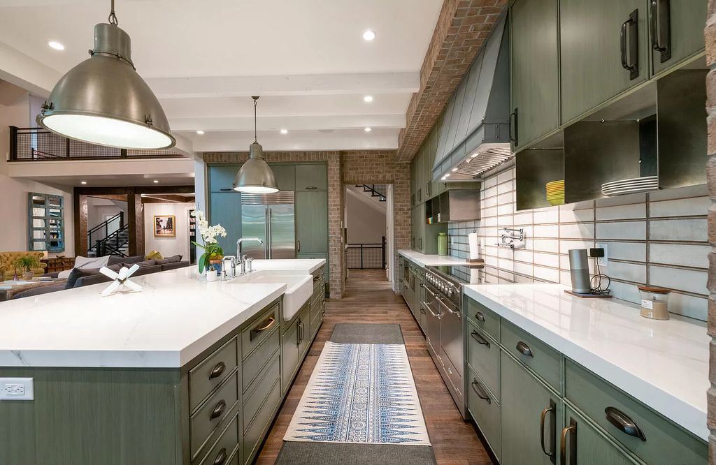 The galley kitchen layout is a smart choice for smaller kitchens because it maximizes the use of space. With two parallel walls featuring cabinets and appliances facing each other, it creates a tight passage that enhances productivity and minimizes wasted space. To increase your workspace and add extra storage, you can easily include a kitchen island or a breakfast bar into a galley kitchen layout.