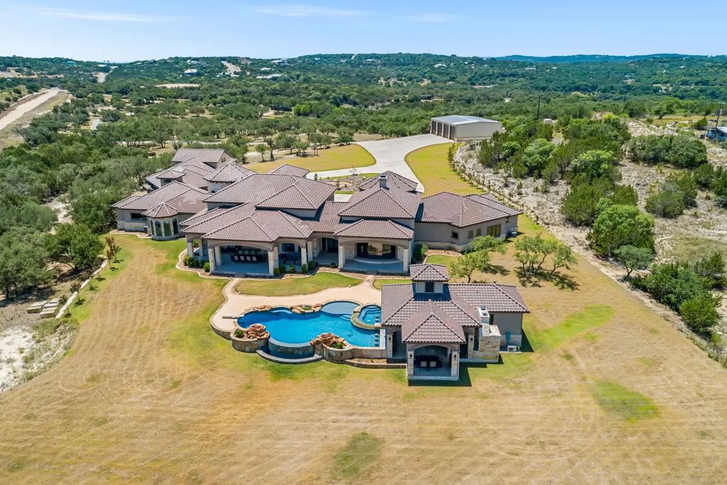 The Estate in Boerne, a one of a kind family compound with rolling hills, a stocked pond, and incredible hilltop views offers impressive entertainment amenities including resort style pool, outdoor kitchen, separate 4 car work shop, gun safe room and more is now available for sale. This home located at 186 Joe Klar Rd, Boerne, Texas