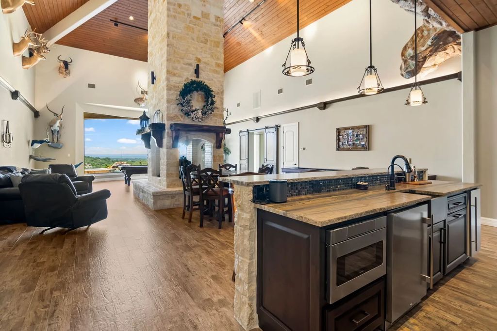 The Estate in Boerne, a one of a kind family compound with rolling hills, a stocked pond, and incredible hilltop views offers impressive entertainment amenities including resort style pool, outdoor kitchen, separate 4 car work shop, gun safe room and more is now available for sale. This home located at 186 Joe Klar Rd, Boerne, Texas