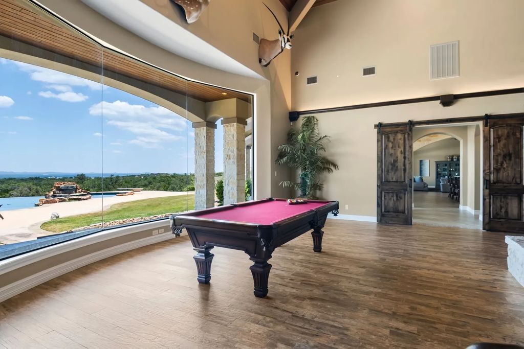 The Estate in Boerne, a one of a kind family compound with rolling hills, a stocked pond, and incredible hilltop views offers impressive entertainment amenities including resort style pool, outdoor kitchen, separate 4 car work shop, gun safe room and more is now available for sale. This home located at 186 Joe Klar Rd, Boerne, Texas