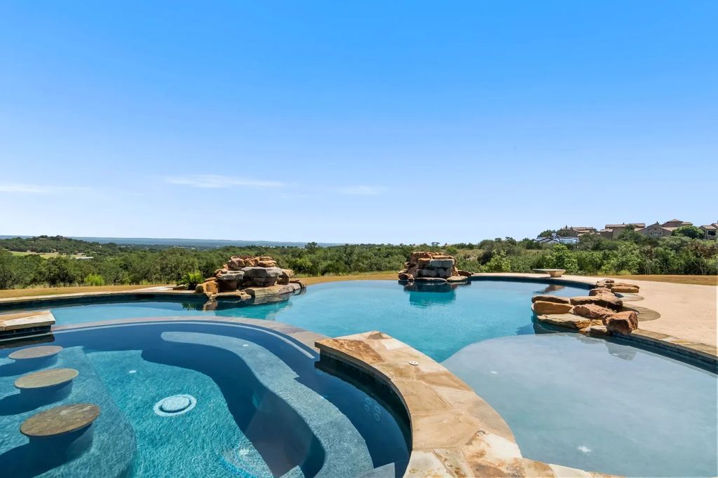 The Estate in Boerne, a one of a kind family compound with rolling hills, a stocked pond, and incredible hilltop views offers impressive entertainment amenities including resort style pool, outdoor kitchen, separate 4 car work shop, gun safe room and more is now available for sale. This home located at 186 Joe Klar Rd, Boerne, Texas