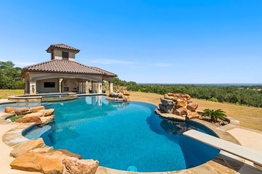 The Estate in Boerne, a one of a kind family compound with rolling hills, a stocked pond, and incredible hilltop views offers impressive entertainment amenities including resort style pool, outdoor kitchen, separate 4 car work shop, gun safe room and more is now available for sale. This home located at 186 Joe Klar Rd, Boerne, Texas