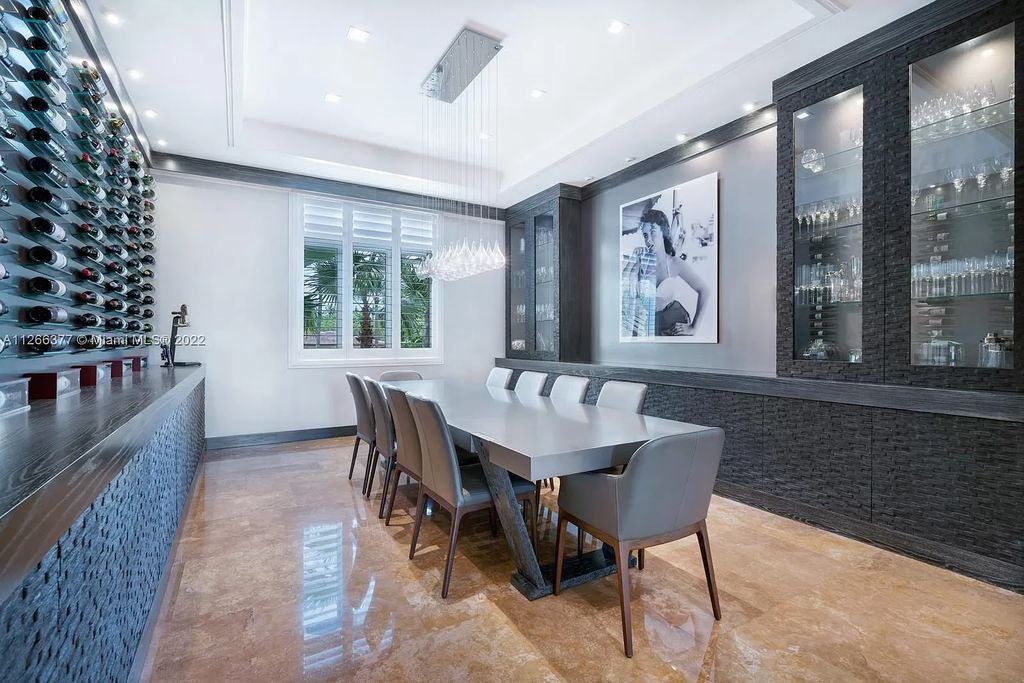 The Home in Coral Gables showcases new modern design concept with two double living spaces and a gourmet chef's kitchen detailed with a standout island and top-of-the-line appliances is now available for sale. This home located at 9335 Balada St, Coral Gables, Florida