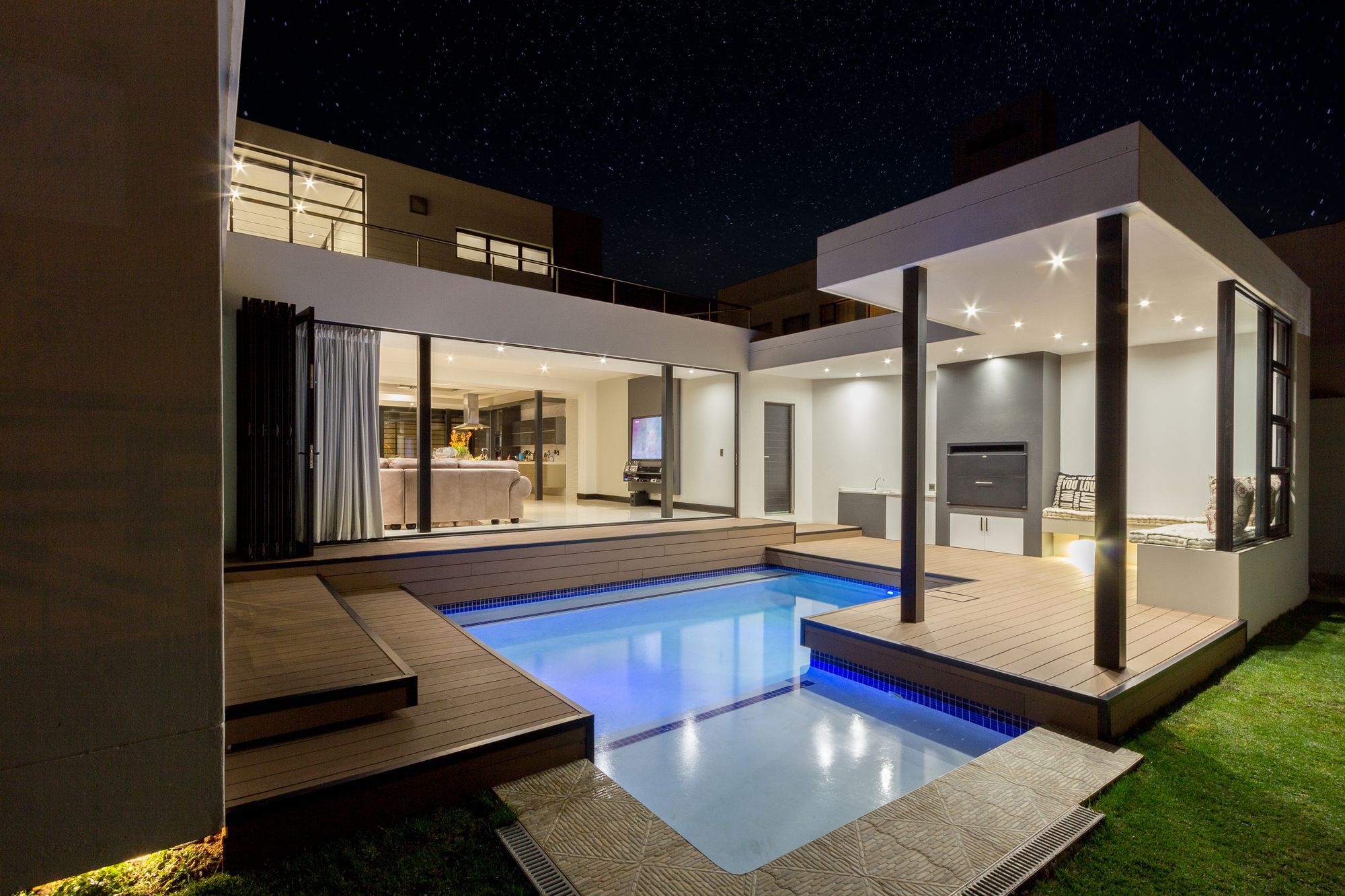 Spread across three different levels, a central courtyard that flows into the rear garden and sparkling recessed lighting put the final touches on a South African home where outdoor living takes precedence.