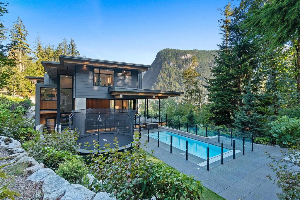 The Home in Squamish offers a backyard for entertaining & play complete with a salt-water pool, in-ground custom hot tub, fire pit, now available for sale. This home located at 38625 High Creek Dr, Squamish, BC V8B 0T6, Canada