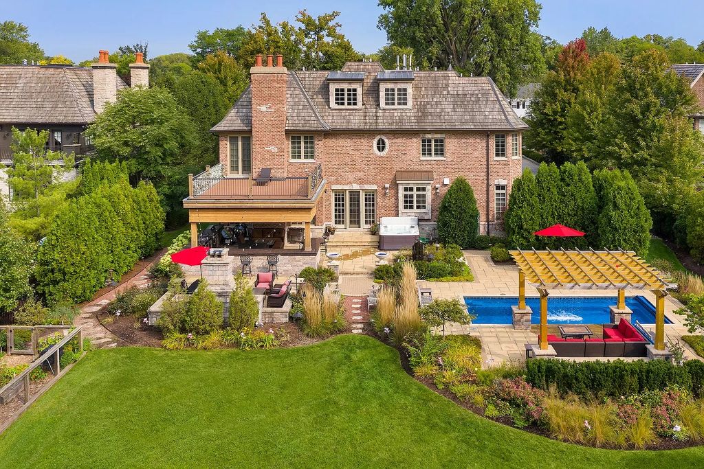 The Home in Winnetka is surrounded with picturesque perennial flower and organic vegetable gardens, lush grounds, now available for sale. This home located at 102 Longmeadow Rd, Winnetka, Illinois