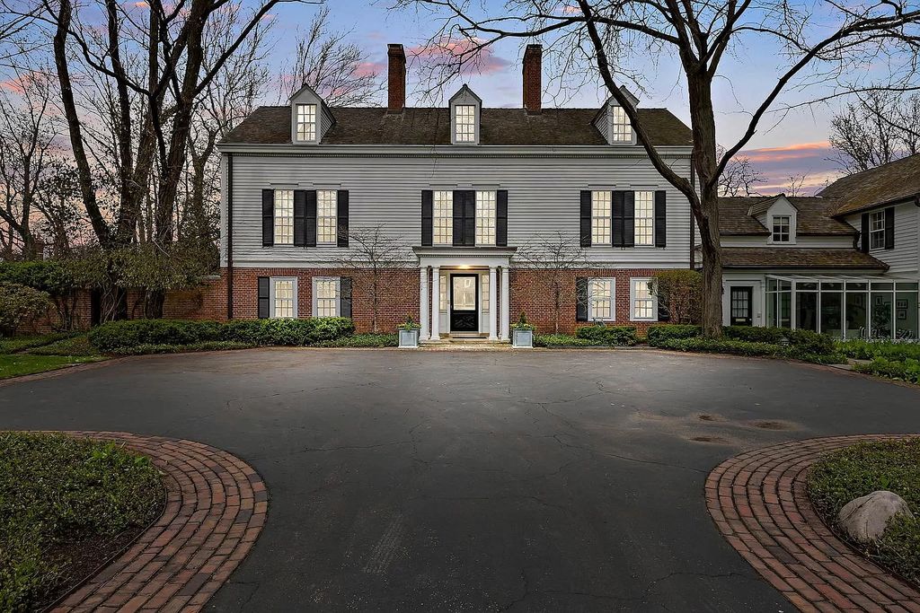 The House in Winnetka offers inviting two-story foyer with curved staircase and marble floors, now available for sale. This home located at 62 Woodley Rd, Winnetka, Illinois