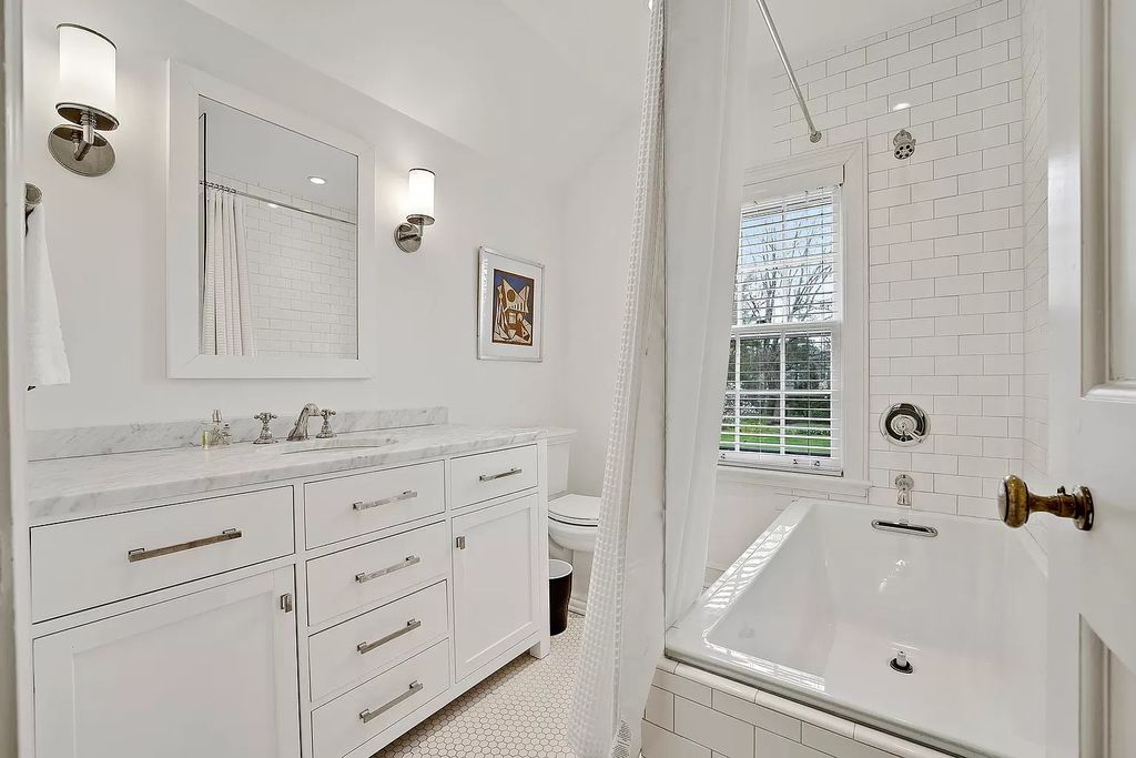 The House in Winnetka offers inviting two-story foyer with curved staircase and marble floors, now available for sale. This home located at 62 Woodley Rd, Winnetka, Illinois