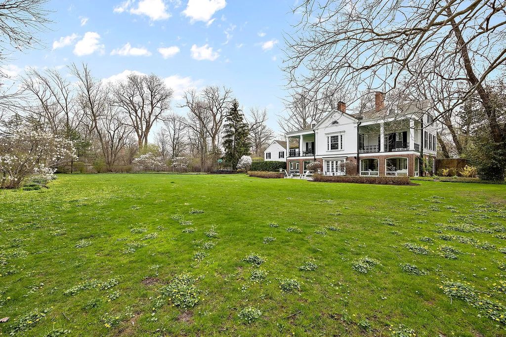 The House in Winnetka offers inviting two-story foyer with curved staircase and marble floors, now available for sale. This home located at 62 Woodley Rd, Winnetka, Illinois