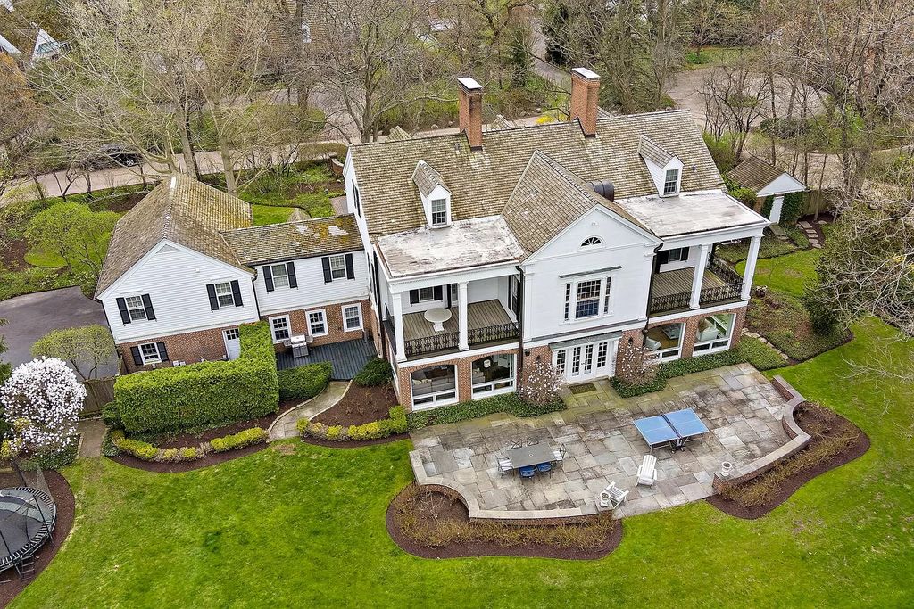 The House in Winnetka offers inviting two-story foyer with curved staircase and marble floors, now available for sale. This home located at 62 Woodley Rd, Winnetka, Illinois