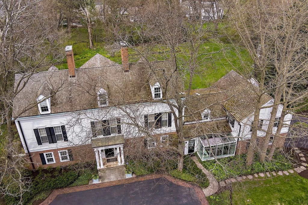 The House in Winnetka offers inviting two-story foyer with curved staircase and marble floors, now available for sale. This home located at 62 Woodley Rd, Winnetka, Illinois