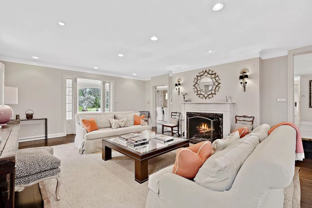 The House in Winnetka offers inviting two-story foyer with curved staircase and marble floors, now available for sale. This home located at 62 Woodley Rd, Winnetka, Illinois