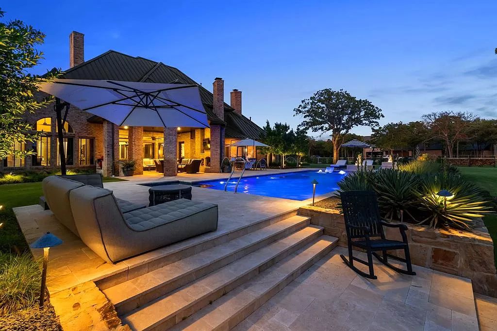 The Estate in Argyle, a stunning home with tranquil setting and a stocked pond offering outdoor oasis with ample covered area with fireplace and both a barbecue and smoker perfect for entertaining is now available for sale. This home located at 1000 Roadrunner Rd, Argyle, Texas