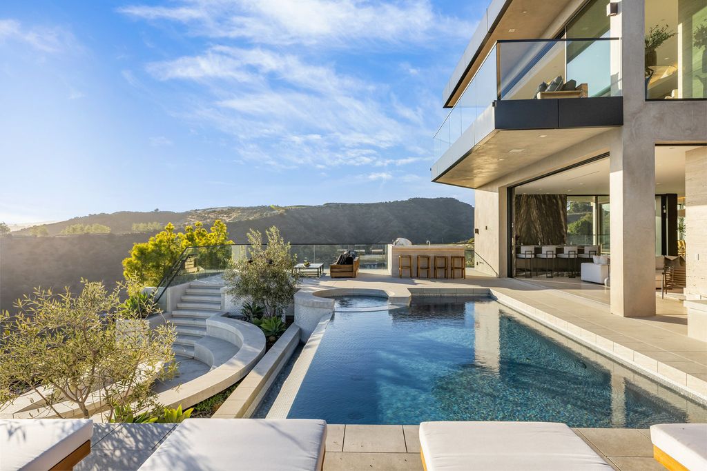 The Mansion in Beverly Hills, a stunning new construction estate features health renewal technology into this Mid-Century inspired modern compound is now available for sale. This home located at 1731 Summitridge Dr, Beverly Hills, California
