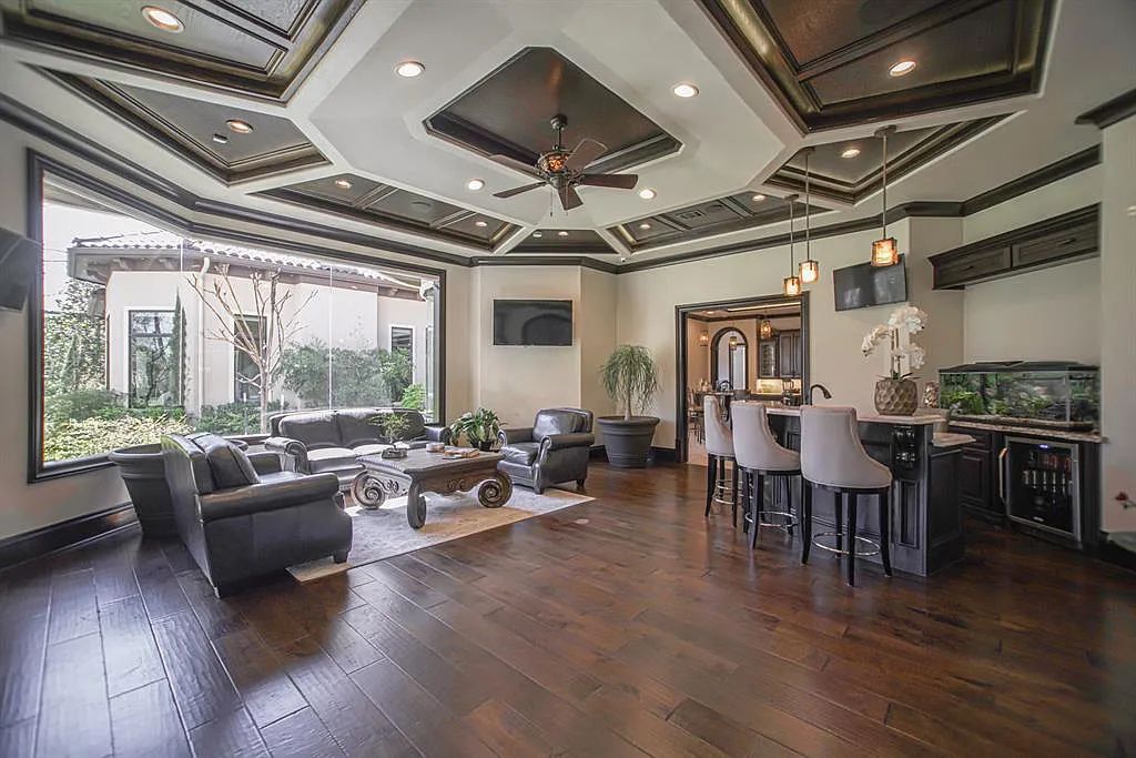 The Home in Spring, a dream property with details in every corner, lots of natural light throughout featuring a floating staircase, covered patio deck with summer kitchen and fireplace and more is now available for sale. This home located at 26 Norlund Way, Spring, Texas