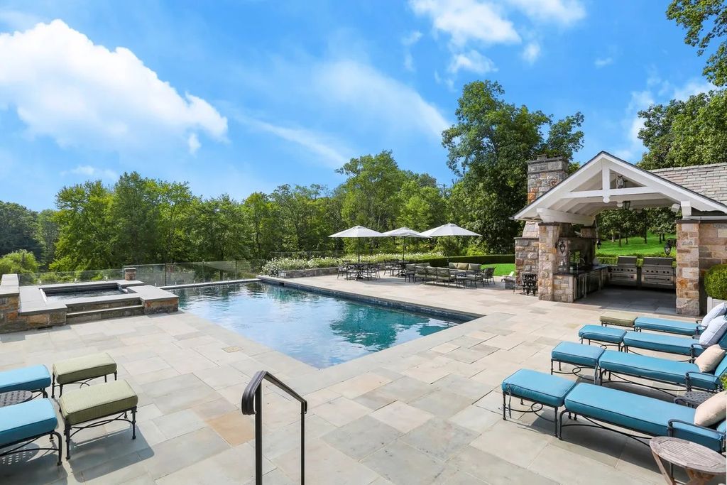 The Manor in Greenwich offers beautiful infinity pool and spa with a pool house, indoor and outdoor showers and outdoor kitchen, now available for sale. This home located at 59 Mooreland Rd, Greenwich, Connecticut