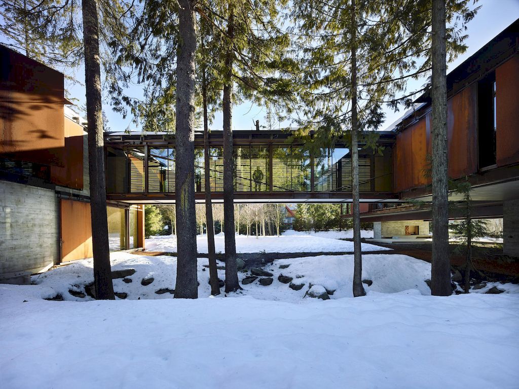 Whistler Ski House in Canada with a glass - walled bridge by Olson Kundig