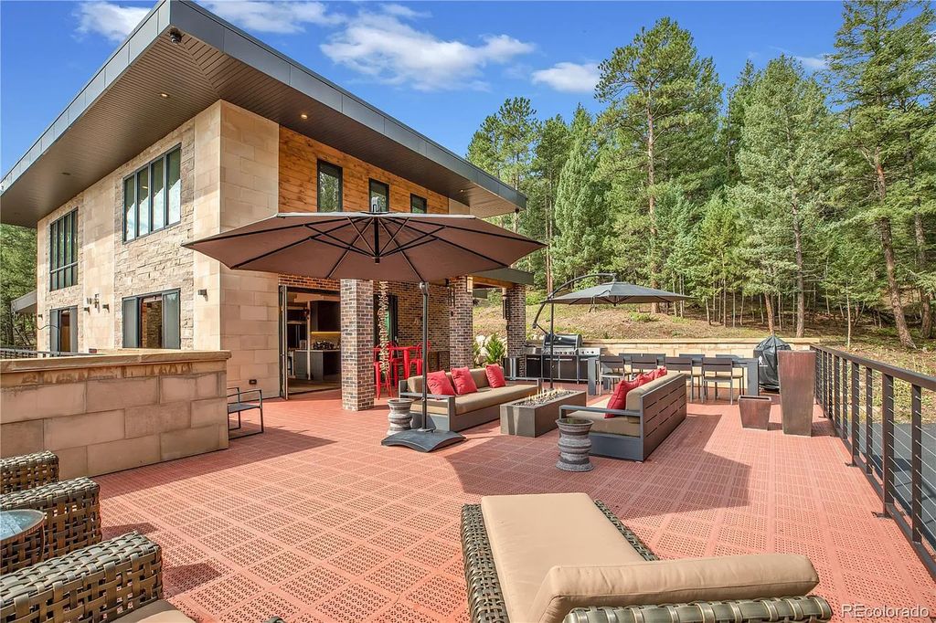 7793 Elk Path Way, Morrison, Colorado is a distinctive architectural style home designed with indoor outdoor living in mind the wrap around deck and patios provide incredible views and entertaining opportunities day and night. 