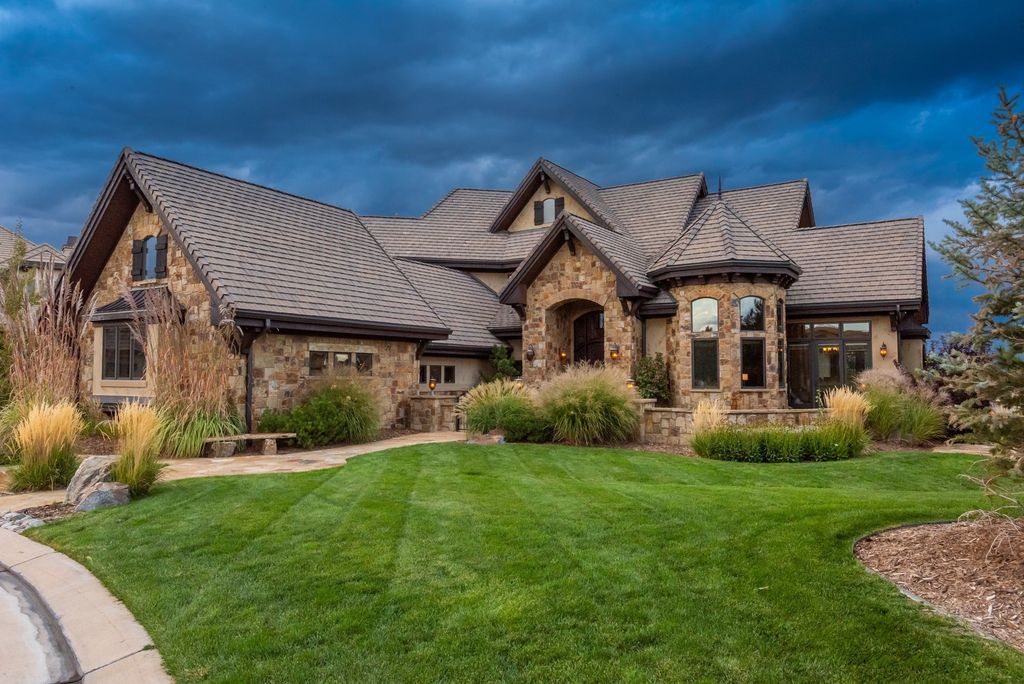 10776 Rainribbon Road, Highlands Ranch, Colorado situated at the end of a quiet Cul-De-Sac with breathtaking mountain views, this custom estate has an outdoor oasis surrounded by lavish landscaping for privacy offering outdoor fireplace, outdoor dining, outdoor kitchen, pool and more are perfect for entertaining.