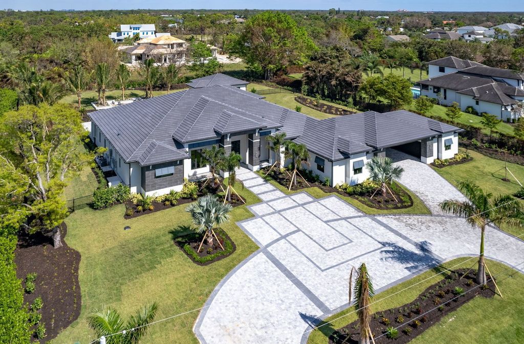 81 North Street, Naples, Florida is a fully furnished single-story residence with open floor plan allows for seamless integration of the indoor and outdoor living space, perfect for entertaining.