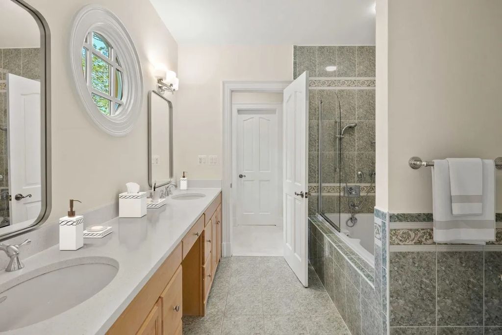 The Home in Bethesda features a private balcony seemingly floating in the woods, while an oversized walk-in closet and spa-inspired bath with separate vanities, now available for sale. This home located at 8814 Chalon Dr, Bethesda, Maryland