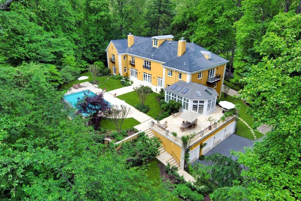 The Home in Bethesda features a private balcony seemingly floating in the woods, while an oversized walk-in closet and spa-inspired bath with separate vanities, now available for sale. This home located at 8814 Chalon Dr, Bethesda, Maryland