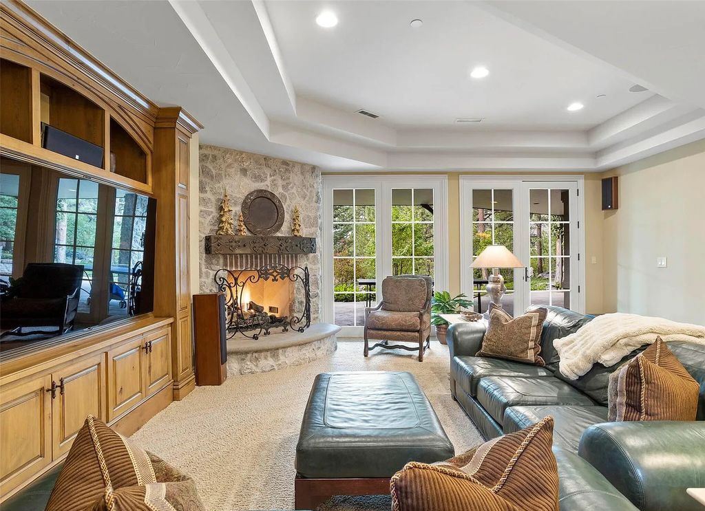 968 Country Club Parkway, Castle Rock, Colorado is stunning residence within the gates of The Village at Castle Pines highlighted by a 2-story vaulted great room with gas fireplace, incredible custom wood beams, window wall, and multiple access points to the large deck with outdoor fireplace.