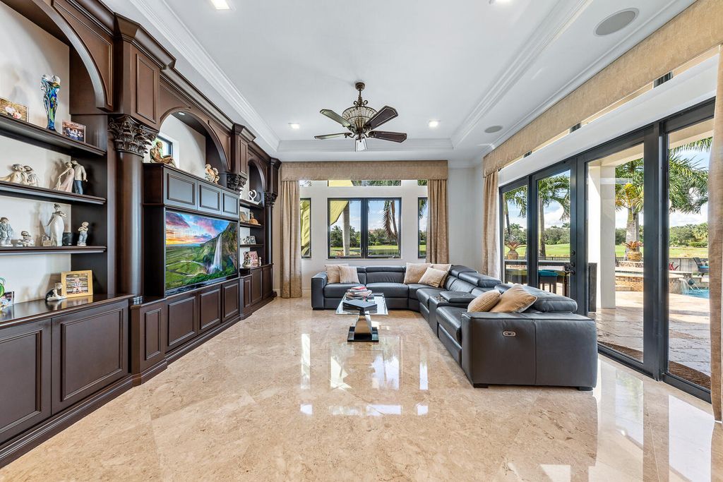 The Home in Parkland, a magnificent mini mansion with a beautiful backyard overlooking rolling fairways, tranquil water and stunning pool area is now available for sale. This home located at 7235 Lemon Grass Dr, Parkland, Florida