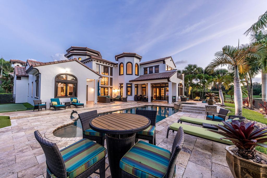 The Home in Parkland, a magnificent mini mansion with a beautiful backyard overlooking rolling fairways, tranquil water and stunning pool area is now available for sale. This home located at 7235 Lemon Grass Dr, Parkland, Florida