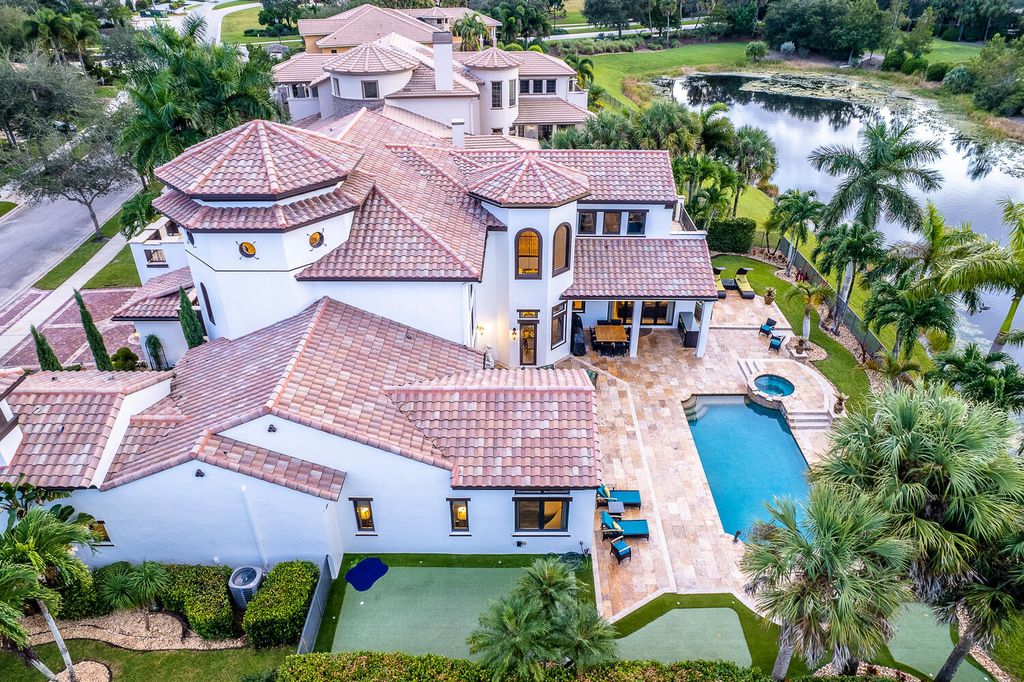 The Home in Parkland, a magnificent mini mansion with a beautiful backyard overlooking rolling fairways, tranquil water and stunning pool area is now available for sale. This home located at 7235 Lemon Grass Dr, Parkland, Florida