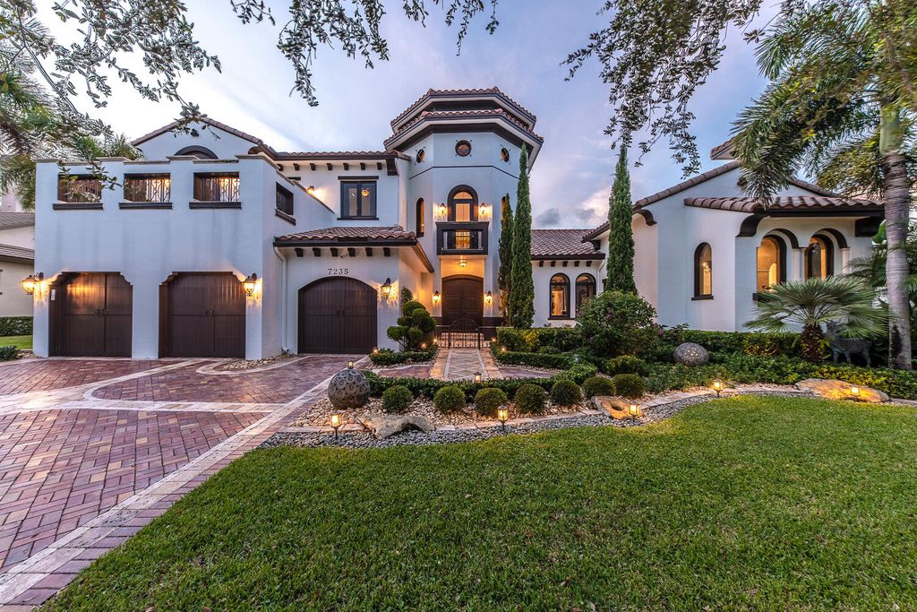 The Home in Parkland, a magnificent mini mansion with a beautiful backyard overlooking rolling fairways, tranquil water and stunning pool area is now available for sale. This home located at 7235 Lemon Grass Dr, Parkland, Florida