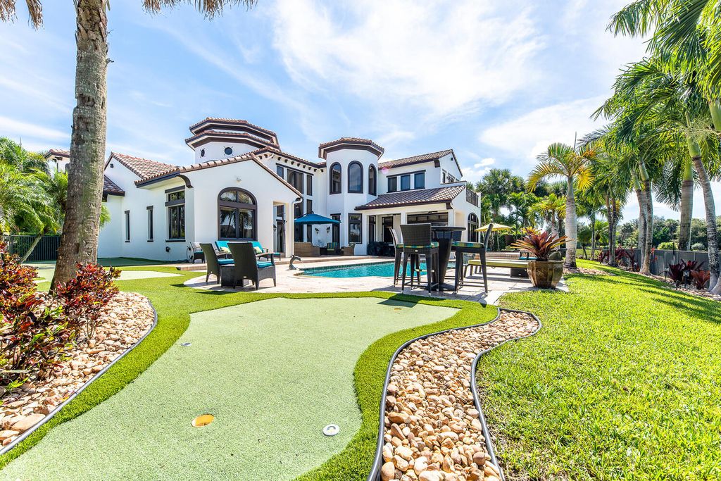 The Home in Parkland, a magnificent mini mansion with a beautiful backyard overlooking rolling fairways, tranquil water and stunning pool area is now available for sale. This home located at 7235 Lemon Grass Dr, Parkland, Florida