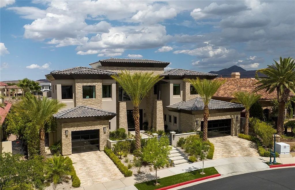 The Villa in Henderson, a custom modern contemporary architecture by Richard Luke offers elegant walk-on-water entrance, movie theater, glass wine cellar, game room, office, elevator, pocket doors, linear fireplaces, and more is now available for sale. This home located at 2656 Mirabella St, Henderson, Nevada