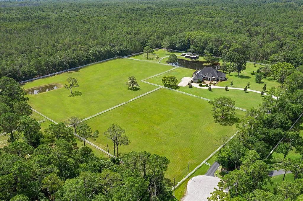 1251 Ranch Road, Tarpon Springs, Florida is a truly one of a kind estate surrounded by the largest natural preserve in Pinellas County spanning over 8700 acres of protected land creating ultimate privacy.