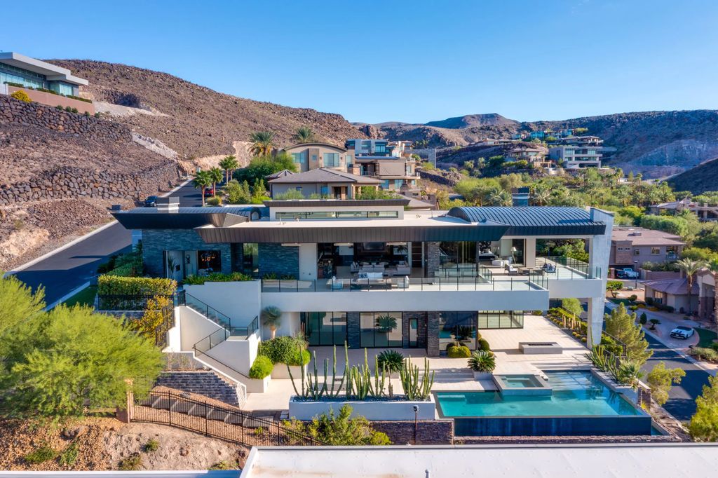 The Home in Henderson, a hilltop sanctuary tucked within luxuriant privacy with sweeping views of mountains, the city, and the strip exudes undeniable ease and grace is now available for sale. This estate located at 509 Dragon Gate Ct, Henderson, Nevada