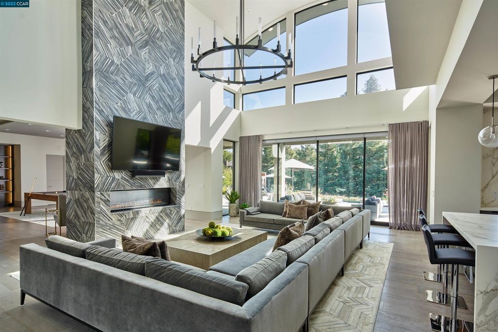 1060 Livorna Road, Alamo, California is a spectacular showplace with luxurious amenities includes 30-foot ceilings, floor-to-ceiling glass, double-sided fireplace, custom lighting, heated Italian wood floors and dual island chef’s kitchen, glass and steel floating staircase and more.