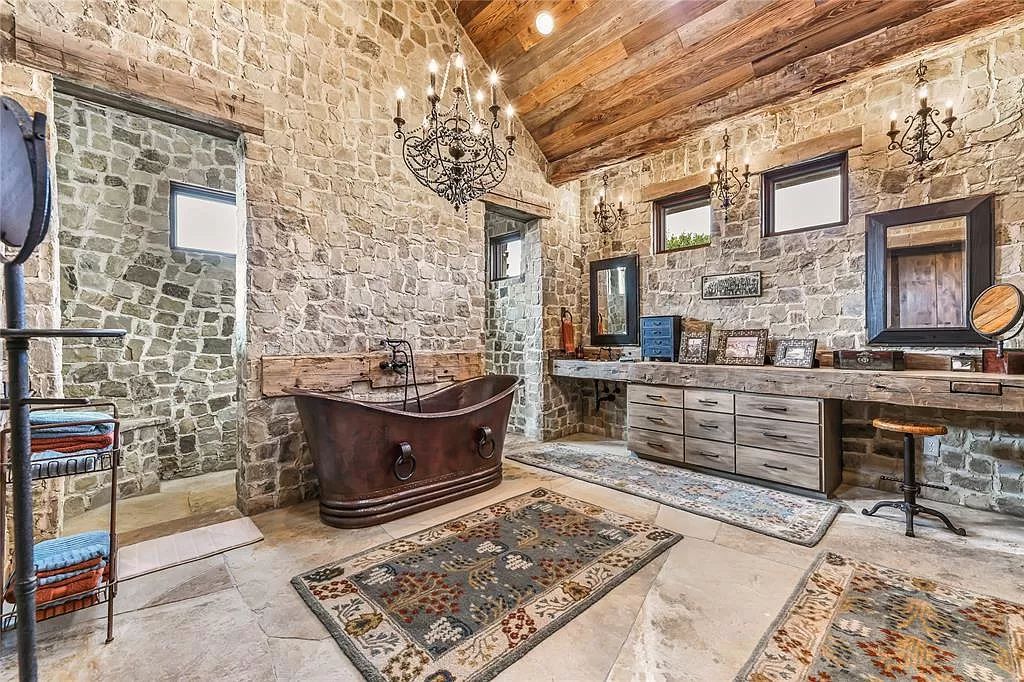 6957 Fm 1361, Somerville, Texas is a Breathtakingly Beautiful Ranch with exquisite detail and thoughtfully planned design featuring a grand open family gathering space and a movie media, game table, open bar and a player piano.