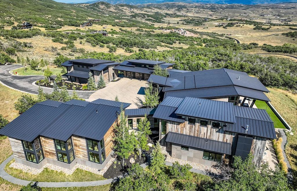 The Estate in Park City is a luxurious home boasting amazing views throughout the region with floor-to-ceiling windows that open to create an amazing indoor/outdoor living space now available for sale. This home located at 9270 Mountain Bluebird Ln, Park City, Utah; offering 07 bedrooms and 08 bathrooms with 10,007 square feet of living spaces.